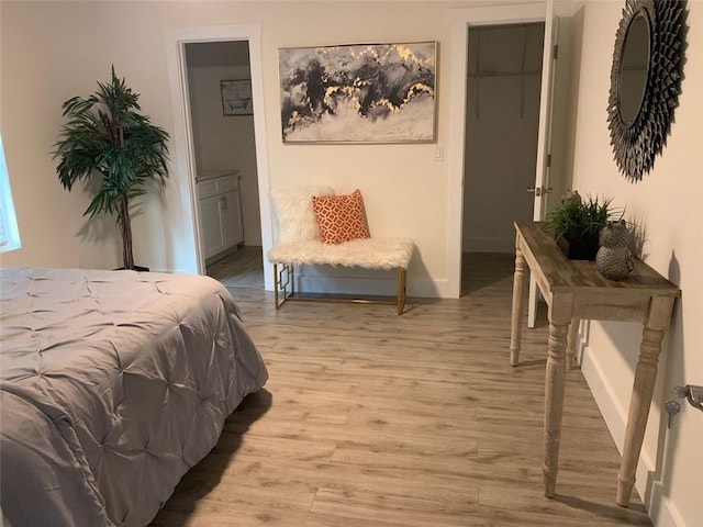 bedroom featuring light hardwood / wood-style flooring, a closet, and a spacious closet