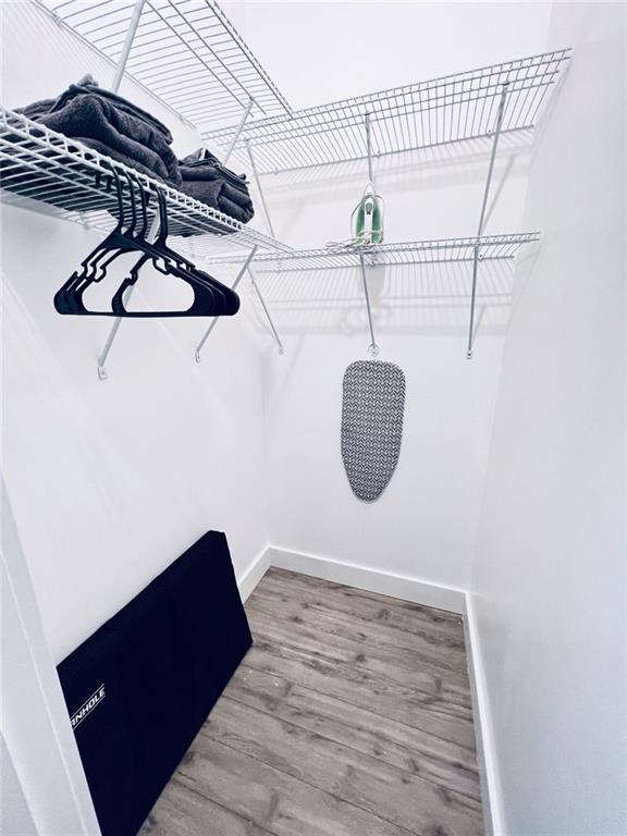 spacious closet featuring hardwood / wood-style floors