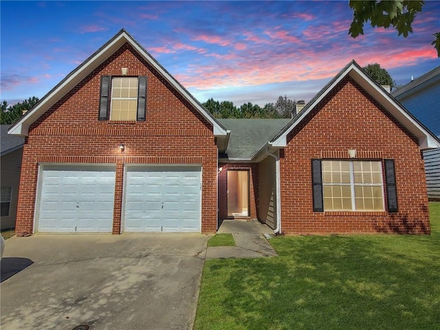 view of property with a garage and a yard