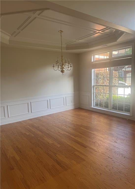 3505 Belridge Ln, Smyrna, GA 30080 - unfurnished dining area featuring coffered ceiling, a chandelier, wood finished floors, crown molding, and a decorative wall