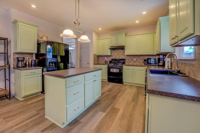 kitchen with black appliances, a center island, light hardwood / wood-style floors, and sink