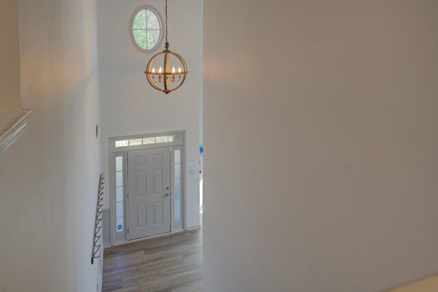 foyer featuring a chandelier and light hardwood / wood-style floors