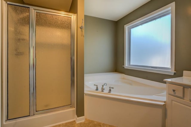 bathroom featuring tile patterned floors, vanity, and shower with separate bathtub