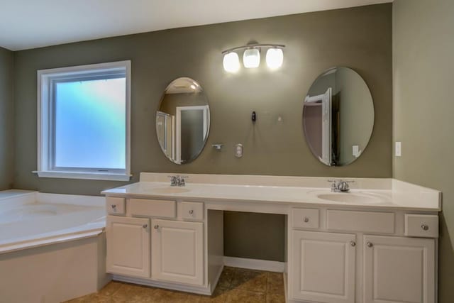 bathroom featuring tile patterned flooring, vanity, and a bathtub