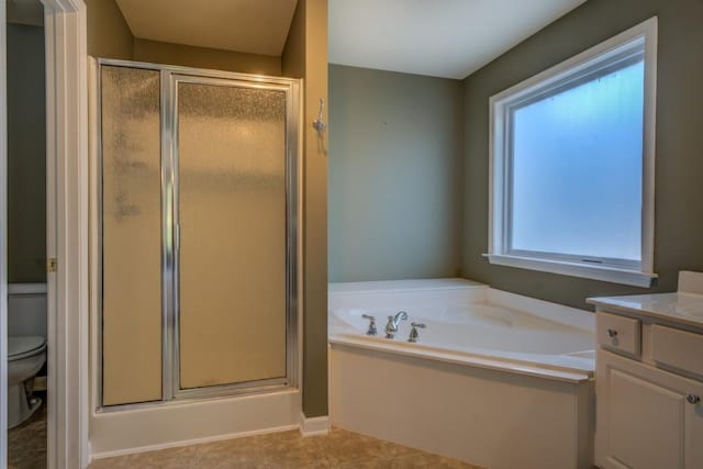 full bathroom featuring vanity, shower with separate bathtub, and a wealth of natural light