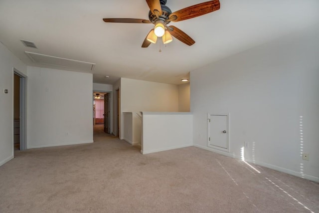 spare room with ceiling fan and light carpet