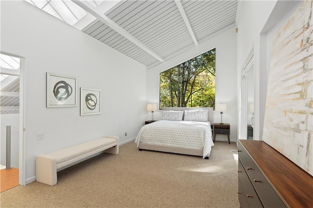 bedroom with wood ceiling, high vaulted ceiling, and light carpet