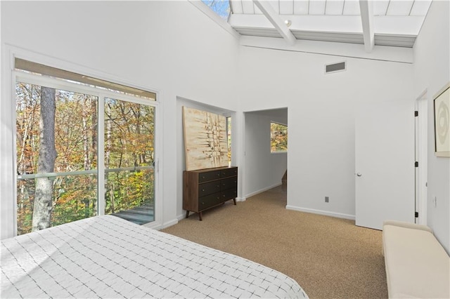 bedroom featuring beamed ceiling, high vaulted ceiling, light carpet, and multiple windows