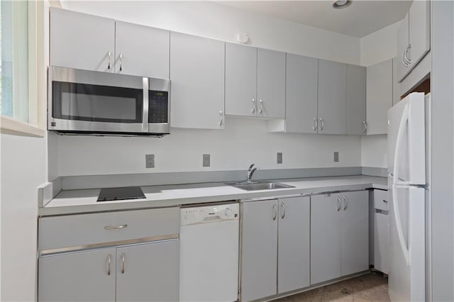 kitchen with gray cabinetry, sink, and white appliances