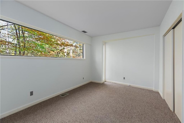 unfurnished bedroom with carpet floors and a closet