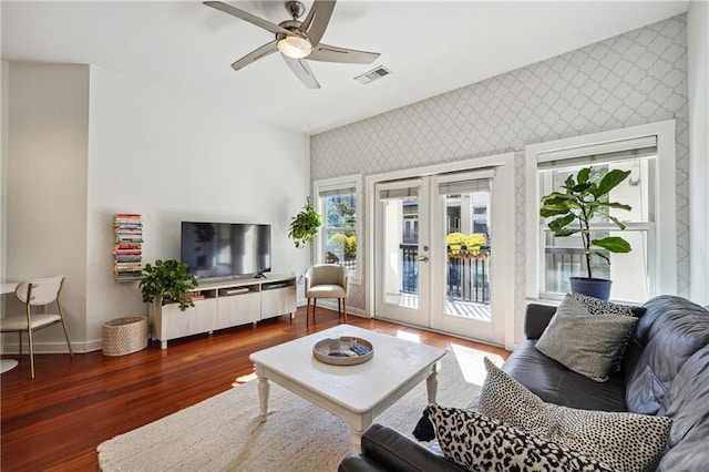 living room featuring wallpapered walls, baseboards, a ceiling fan, dark wood-style floors, and french doors