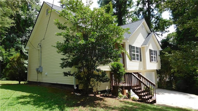 view of front of property with a garage and a front lawn