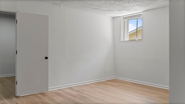 3735 Benchmark Dr, Atlanta, GA 30349 - unfurnished room with a textured ceiling, wood finished floors, and baseboards