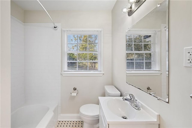 full bathroom featuring vanity, tiled shower / bath combo, and toilet