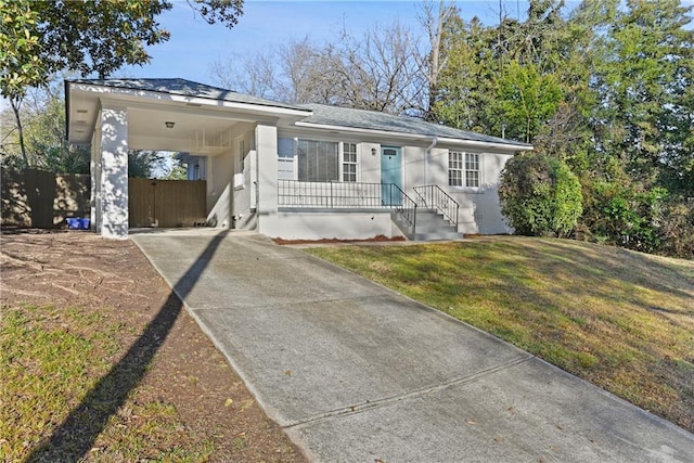 ranch-style house featuring a carport and a front yard