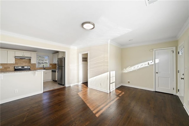 unfurnished living room featuring dark hardwood / wood-style flooring, sink, and crown molding