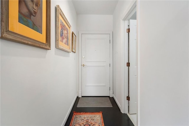 hallway featuring baseboards