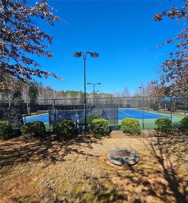 view of sport court featuring fence