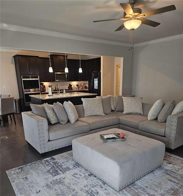 living room with a ceiling fan, dark wood finished floors, and crown molding