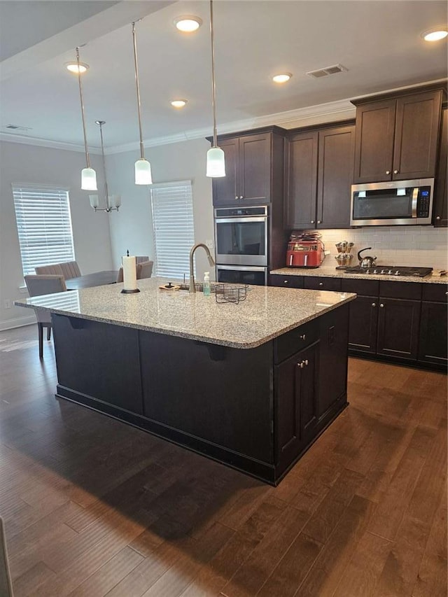 kitchen with visible vents, appliances with stainless steel finishes, tasteful backsplash, dark wood finished floors, and crown molding