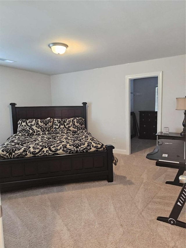 bedroom with light carpet and baseboards