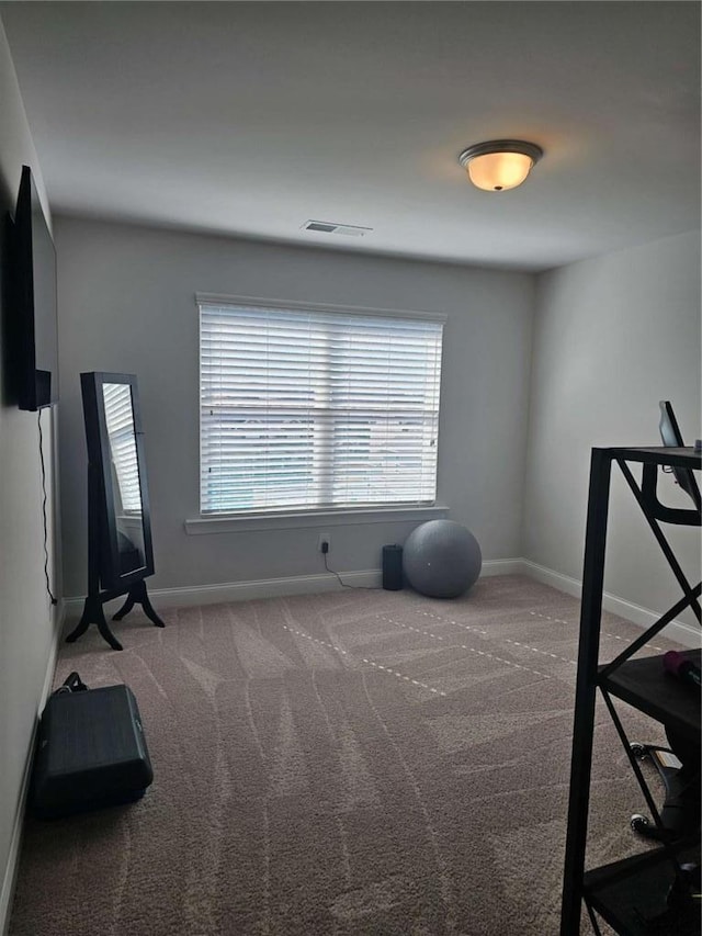 exercise room with carpet floors, visible vents, and baseboards