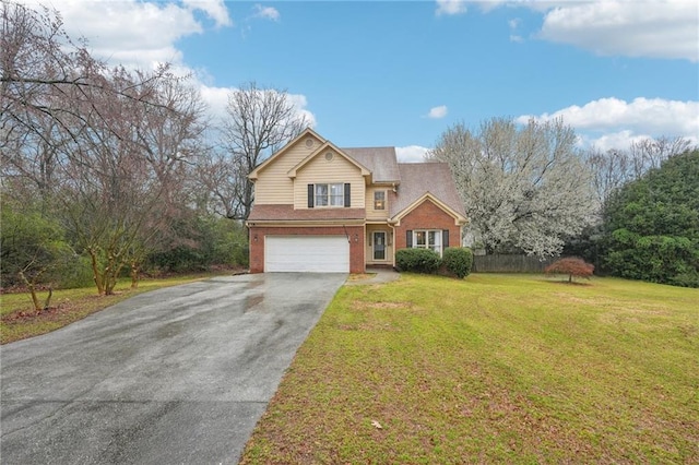 traditional home featuring brick siding, a front lawn, fence, a garage, and driveway