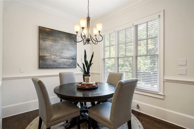 dining area featuring baseboards, dark wood finished floors, crown molding, and a chandelier