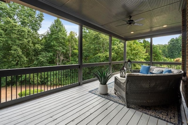 wooden deck with a ceiling fan and outdoor lounge area