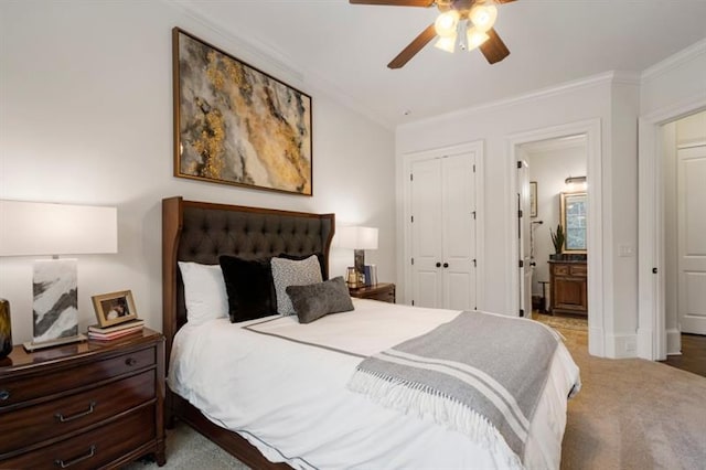 bedroom featuring carpet floors, a closet, crown molding, and ensuite bath