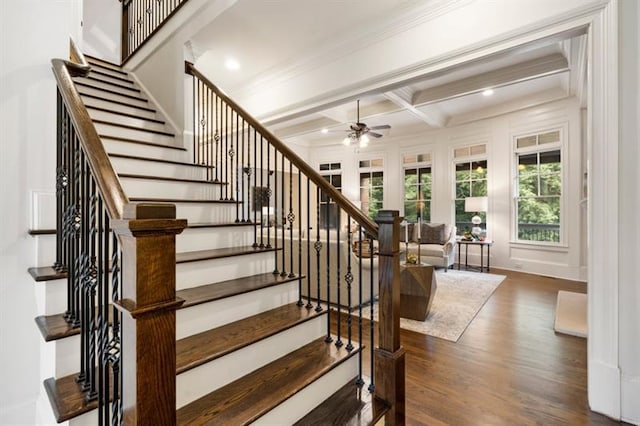 stairs with crown molding, a ceiling fan, wood finished floors, coffered ceiling, and beamed ceiling