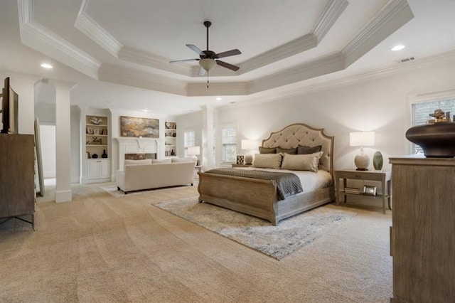 bedroom with visible vents, a raised ceiling, carpet, ornate columns, and recessed lighting