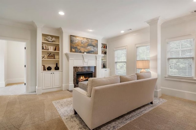 living area with recessed lighting, ornamental molding, a high end fireplace, light carpet, and baseboards