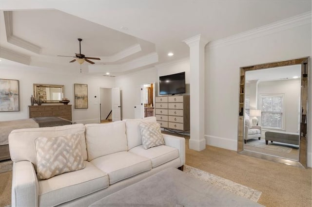 living area with baseboards, a raised ceiling, a ceiling fan, crown molding, and recessed lighting