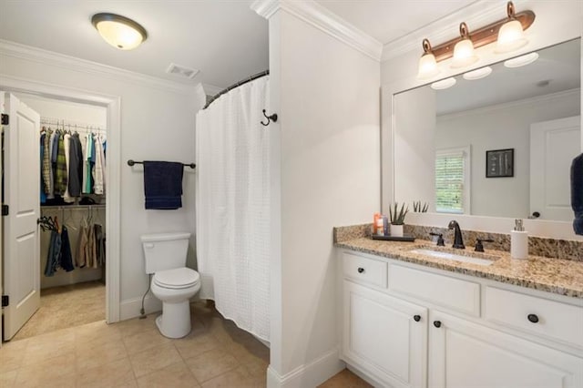 bathroom featuring tile patterned flooring, toilet, vanity, baseboards, and ornamental molding