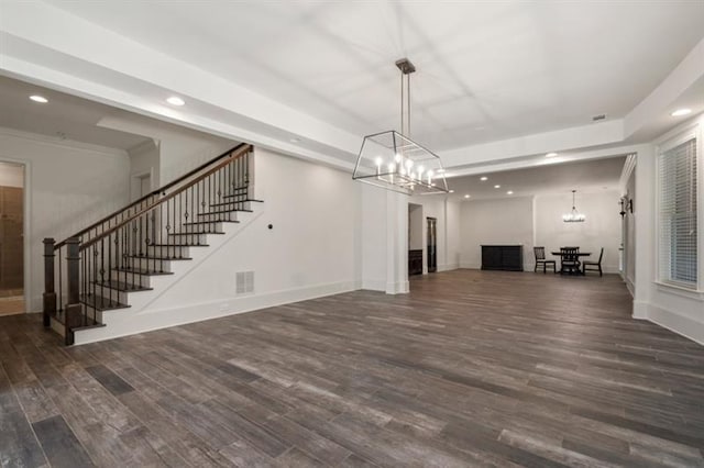 unfurnished living room with recessed lighting, wood finished floors, visible vents, baseboards, and stairway