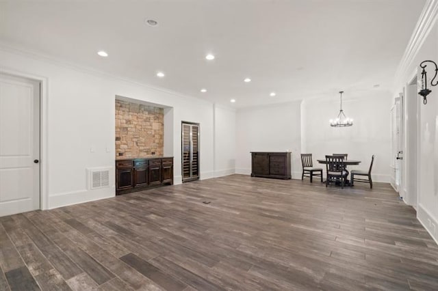 unfurnished living room featuring dark wood-style floors, recessed lighting, visible vents, and ornamental molding