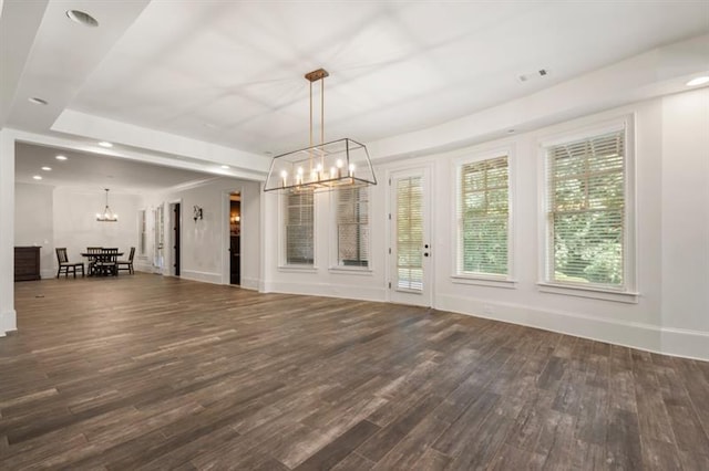 unfurnished dining area featuring a chandelier, recessed lighting, baseboards, and wood finished floors