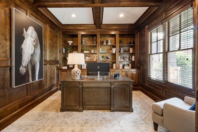 office space with built in shelves, wood walls, coffered ceiling, ornamental molding, and beam ceiling