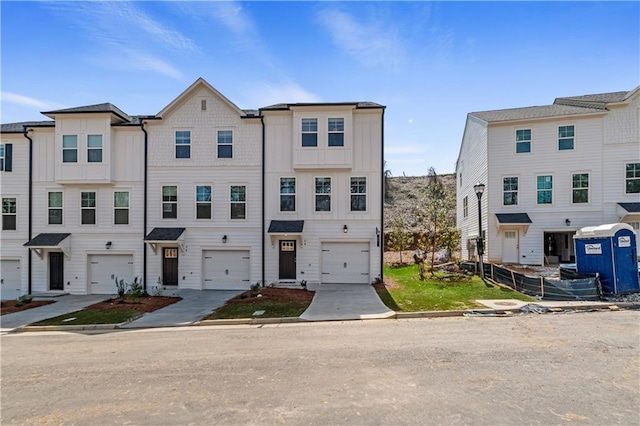 multi unit property featuring driveway and a garage