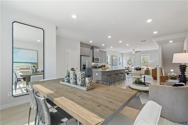 dining space with ceiling fan, recessed lighting, visible vents, baseboards, and light wood finished floors