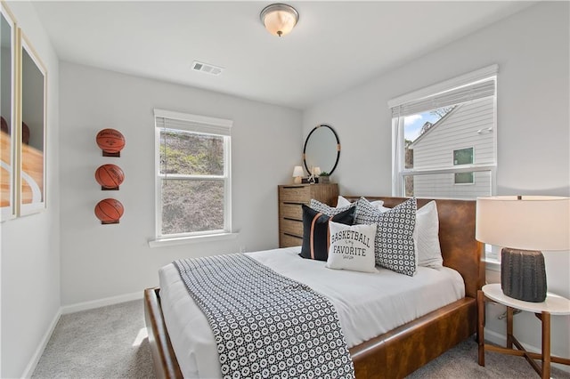 bedroom with multiple windows, carpet flooring, visible vents, and baseboards