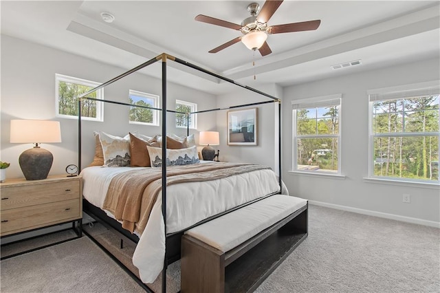 carpeted bedroom with ceiling fan, visible vents, and baseboards