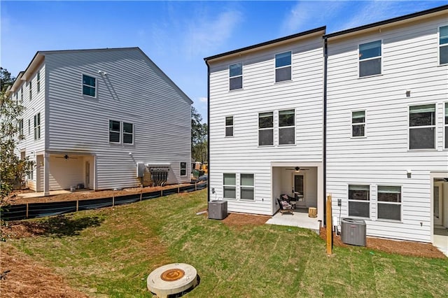 back of house featuring an outdoor fire pit, central AC, a patio, and a lawn