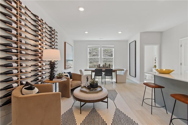 living area with light wood-type flooring and recessed lighting