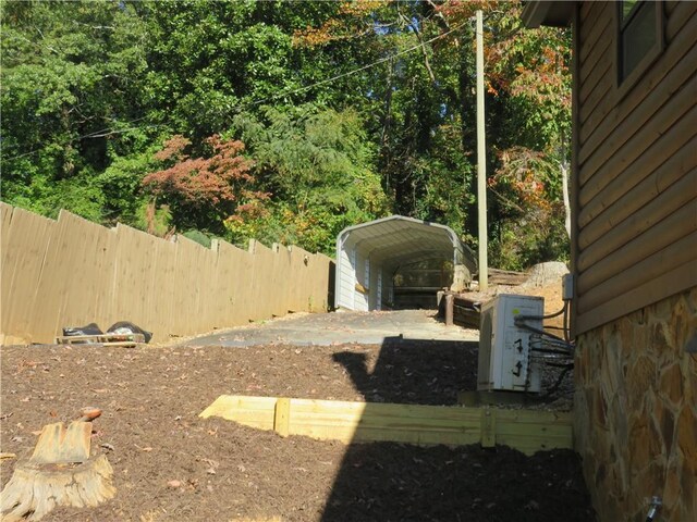 view of yard featuring fence and a detached carport