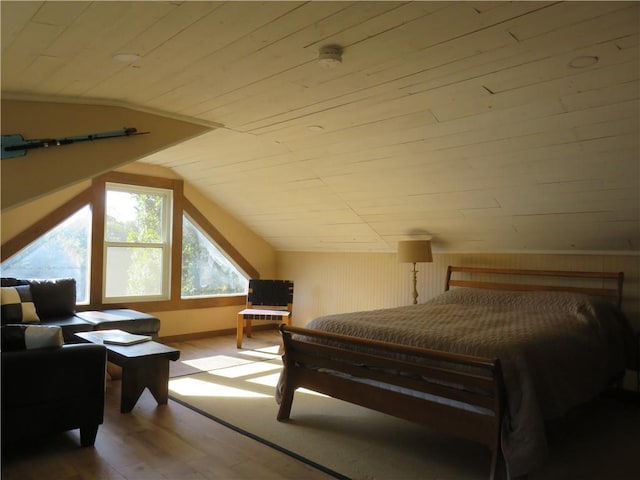 bedroom with lofted ceiling, wooden ceiling, and hardwood / wood-style flooring