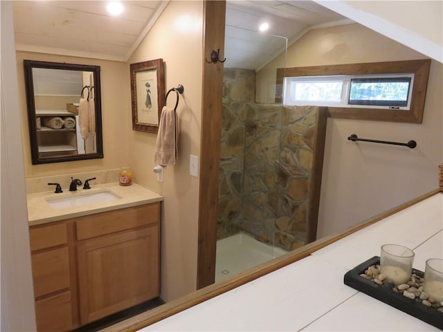 full bathroom with walk in shower, lofted ceiling, and vanity