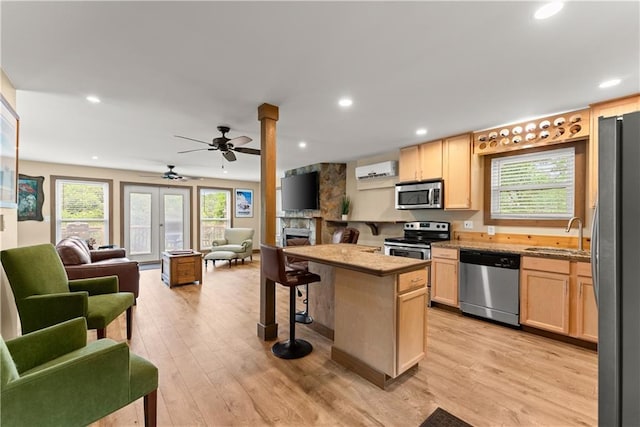 2109 Pine Tree Cir, Gainesville, GA 30501 - kitchen with stainless steel appliances, light brown cabinets, open floor plan, a sink, and recessed lighting