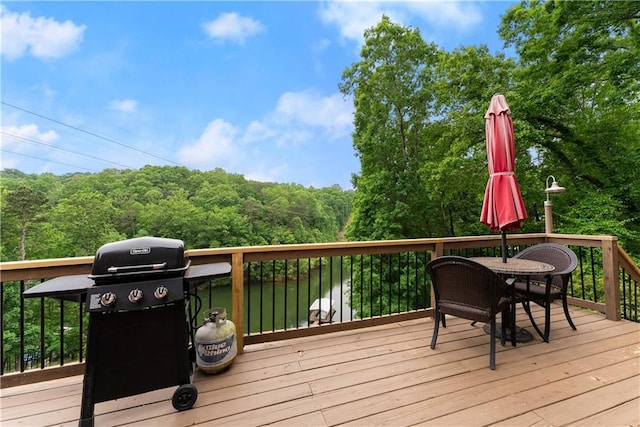 2109 Pine Tree Cir, Gainesville, GA 30501 - wooden terrace with grilling area, outdoor dining space, and a forest view